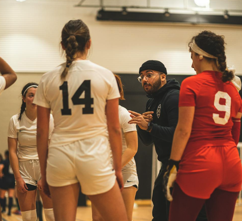 Coach standing on a soccer field during practice